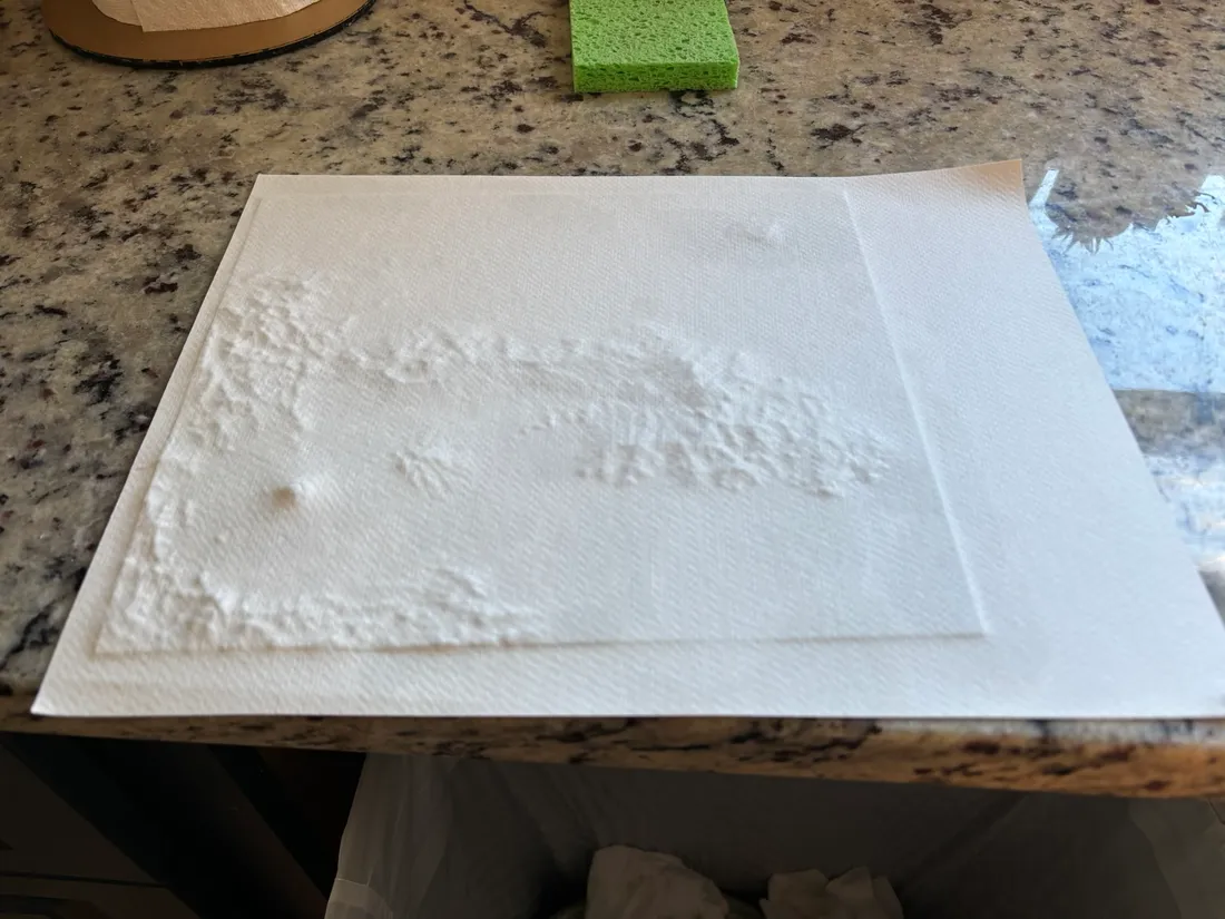 Paper draped and drying over the terrain